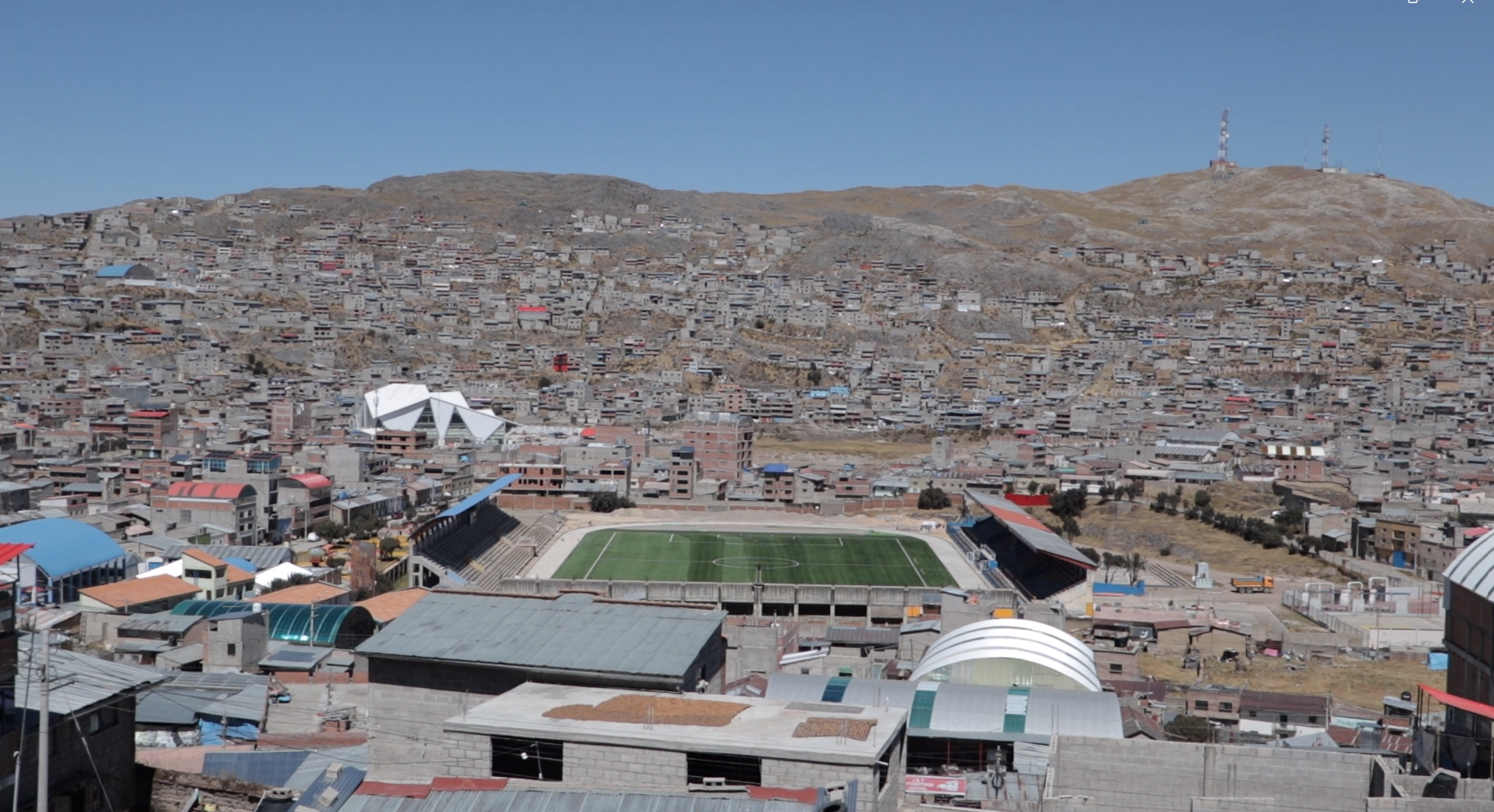 Cerro de Pasco seen from above, with the city surrounding a football stadium and hillsides