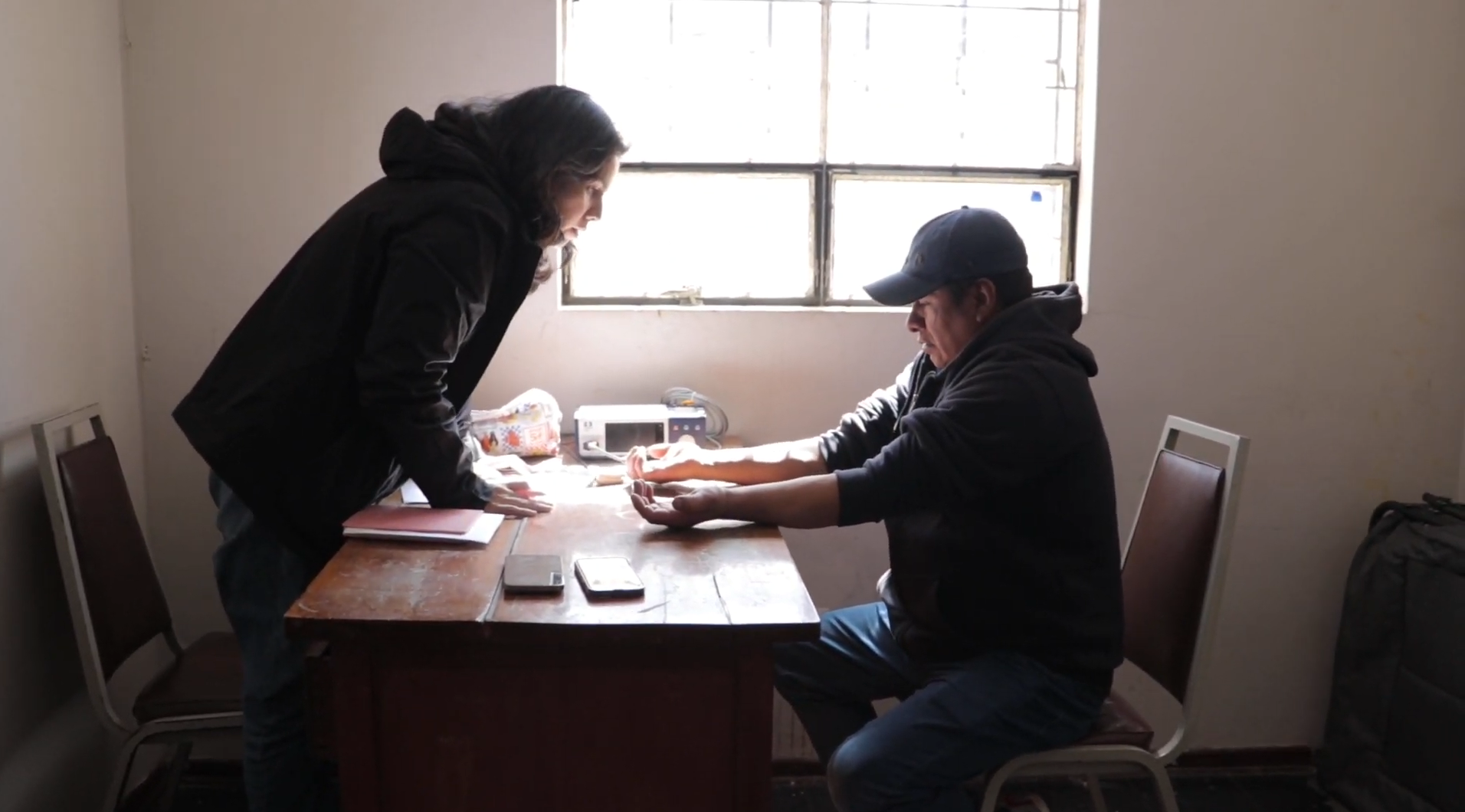 Researcher explaining a procedure to a participant in the field laboratory