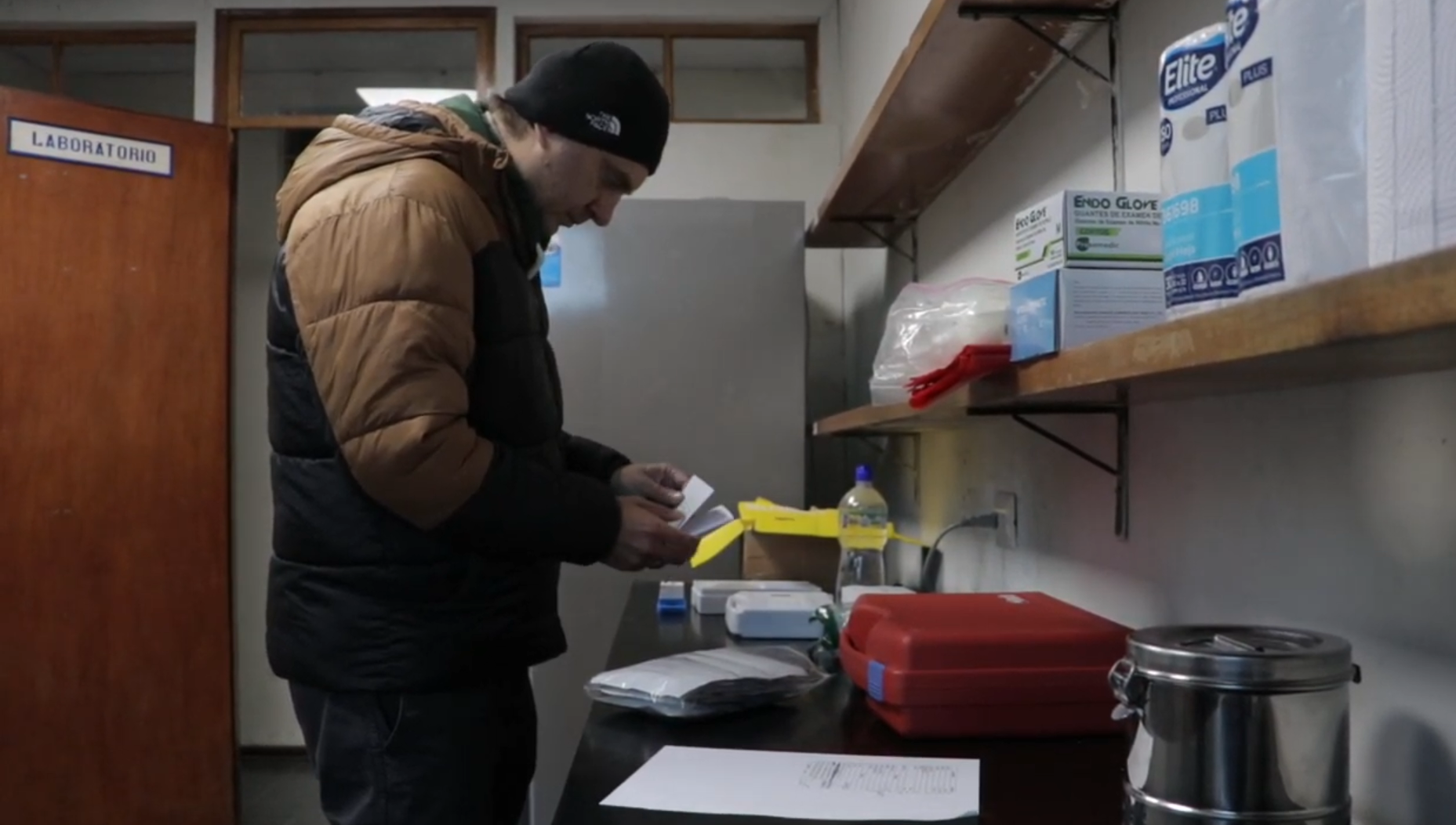 Researcher preparing materials inside the Cerro de Pasco field laboratory